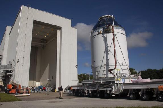 The Orion capsule sits on top of the service module as it is moved from the Operations & Checkout Building to the Payload Hazardous Servicing Facility at Kennedy Space Center